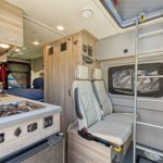 el-monte-class-b-small-rv-4-berth-interior-front-seats-and-kitchen